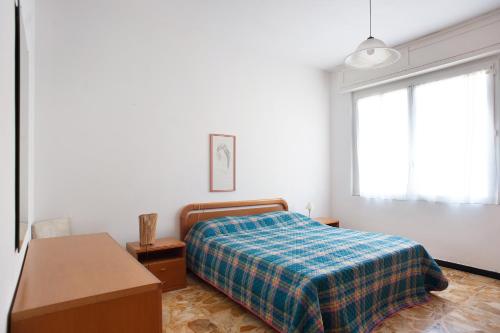 a bedroom with a bed and a desk and a window at Casa Bruno e Iris in Levanto