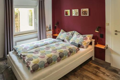 a bedroom with a bed with a comforter and a window at Ferienwohnung Malerstübchen in Willingen