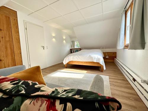 a bedroom with a bed and a window at Backhüsli am Bauerngarten in St. Blasien