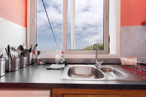 a kitchen counter with a sink and a window at Casa Sirius in Tijarafe