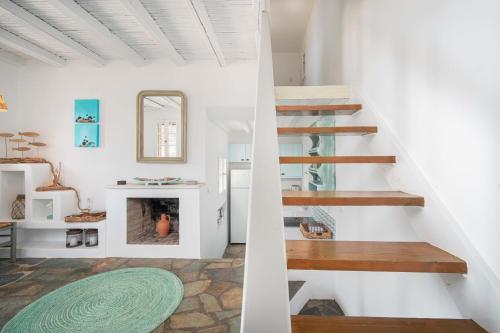 a living room with stairs and a fireplace at Karavi in Rámos