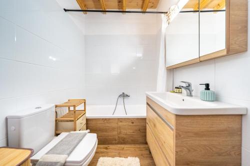 a bathroom with a toilet and a sink and a tub at Arianna Grand apartment in Corfu