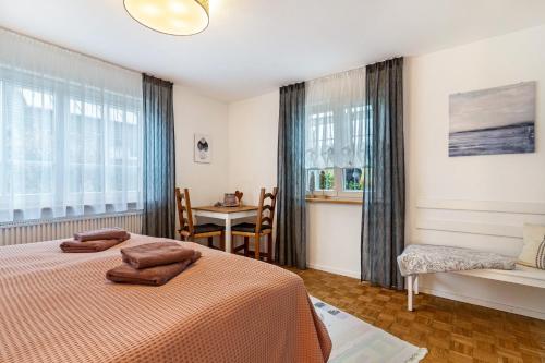 a bedroom with two beds and a table and a chair at Ferienwohnung Schätzle in Schuttertal
