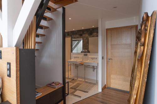 a bathroom with two sinks and a staircase in a house at Suite Cathédrale - Ty Castel in Ploeren