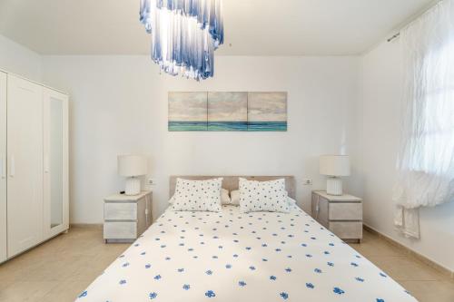 a bedroom with a bed and two night stands at Villa Cassis in Adeje