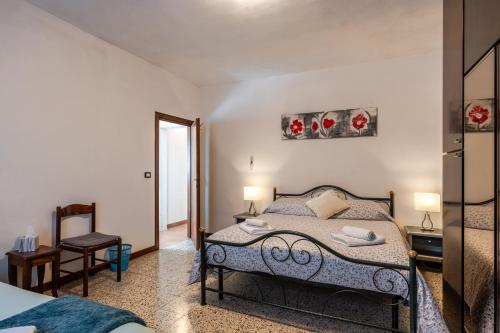 a bedroom with a bed and a table and a chair at Casa Simi - Holiday Home in Chiesina Uzzanese