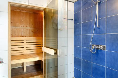 a bathroom with a shower and a sauna at Landhüsli Illmensee in Illmensee