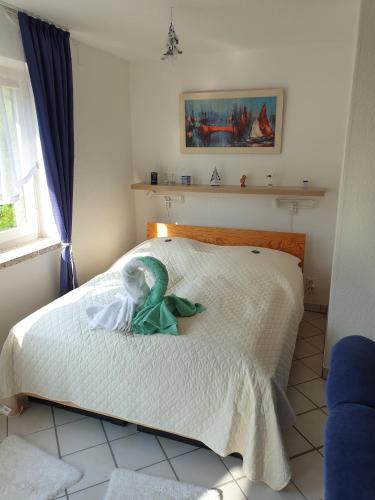 a bedroom with a bed with a green mermaid on it at Ferienwohnung Strandperle-Schilksee in Schilksee