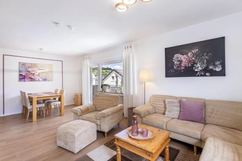 a living room with a couch and a table at Annes Stübchen in Schmallenberg