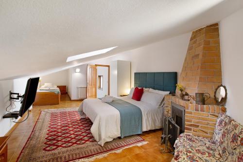 a bedroom with a large bed and a fireplace at Carmelo y Carmela 6 in Teror