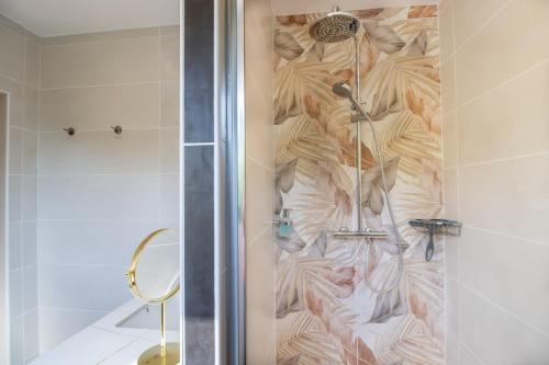 a shower with a glass door in a bathroom at Gite le Pic Epeiche in Sarlat-la-Canéda