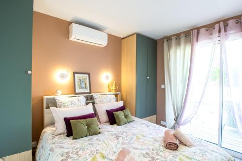 a bedroom with a large bed and a window at Gite le Pic Epeiche in Sarlat-la-Canéda
