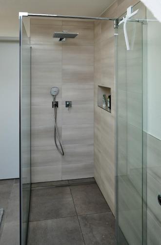 a shower in a bathroom with a glass door at Ferienwohnung Munzert - Bodensee in Langenargen