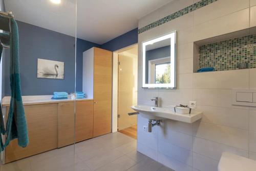 a bathroom with a sink and a shower at Appartements Bank Am See in Immenstaad am Bodensee