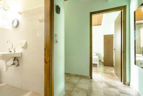 a bathroom with a sink and a mirror at Old Boat apartment in Nikiana