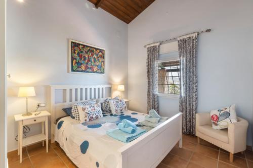 a bedroom with a bed and a chair in it at Vivero El Suso in La Manga del Mar Menor
