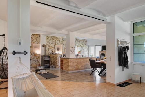 a living room with a fireplace and a table at Hof Musial in Pokrent