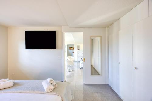 a bedroom with a bed and a television on a wall at Residence Margherita in Ugento