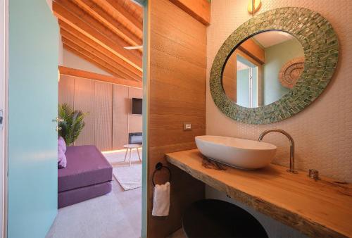 a bathroom with a sink and a mirror on the wall at Ca' Marano Apartments in Centro