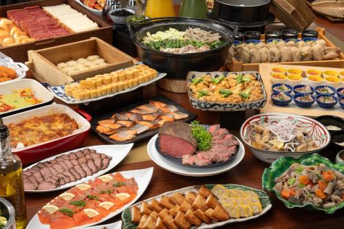 a table topped with lots of different types of food at Hotel Trad Hakata in Fukuoka
