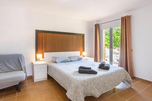 a bedroom with a bed with two towels on it at Disfruta De La Costa Brava in Lloret de Mar