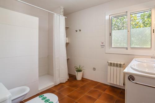 a bathroom with a sink and a toilet and a window at Disfruta De La Costa Brava in Lloret de Mar