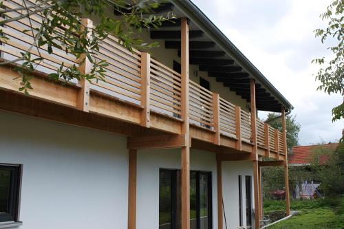 a wooden deck on the side of a house at Gästehaus 26 I 2 in Bad Urach