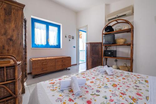 a bedroom with a bed and a dresser at Jerà Suite Vista Mare in Lipari