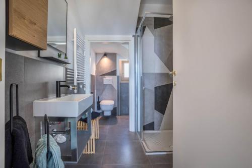 a bathroom with a sink and a toilet at Casa Panoramica in Tignale