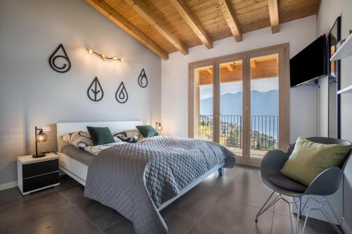 a bedroom with a bed and a large window at Casa Panoramica in Tignale