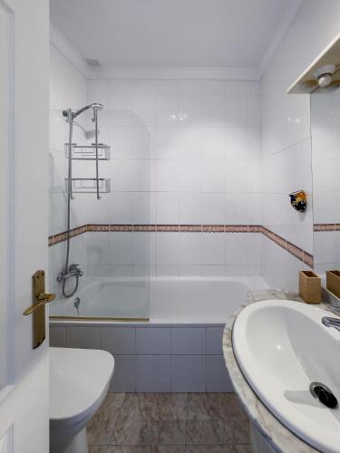 a white bathroom with a tub and a sink at Rd02 La Casa Hermosa in Torrox