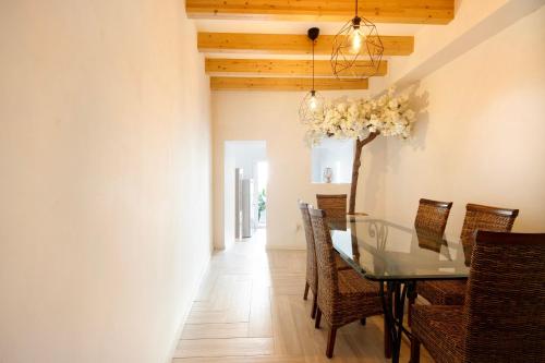 a dining room with a glass table and chairs at Lidador House Vila do Conde in Vila do Conde