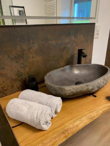 a bathroom with a large stone sink and a towel at Ferienhaus auffm Hebberg in Attendorn