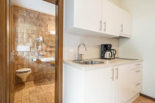 a small bathroom with a sink and a toilet at Residence Kronstein - Fewo 4 in Tesimo