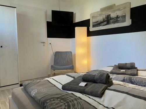 a bedroom with a bed and a blue chair at Ferienwohnung Sauerlandherz in Lennestadt