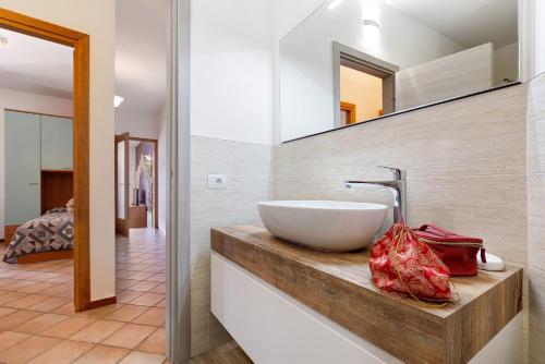 a bathroom with a bowl sink and a mirror at Rustico Spagnol 1 in Tignale
