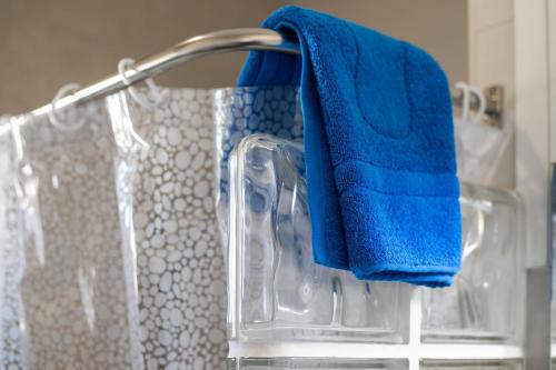 a blue towel is hanging on a rack in a bathroom at Apartamento Marei 3 in Cala Blanca