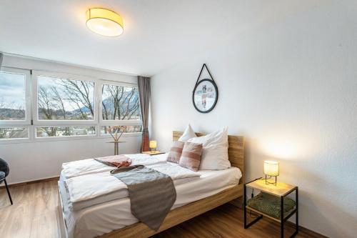 a bedroom with a bed with a clock on the wall at The view 2 in Bad Reichenhall