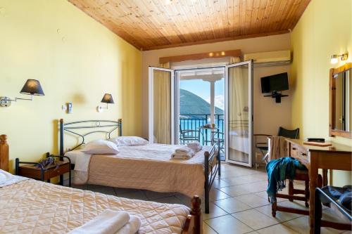 a bedroom with two beds and a balcony at Apostolos Apartment 6 in Póndi