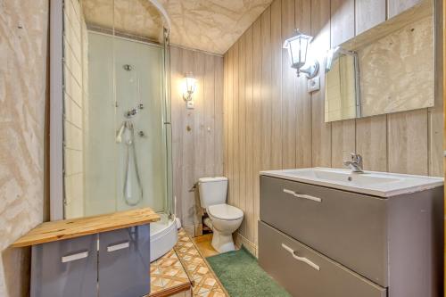 a bathroom with a shower and a sink and a toilet at La Grange in Guizengeard
