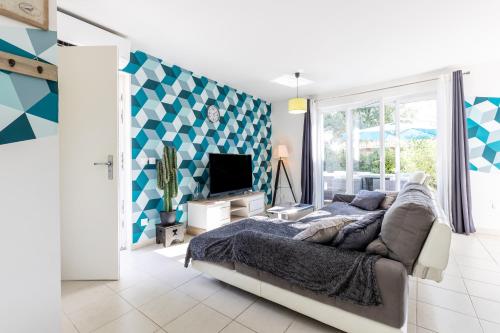 a bedroom with a bed and a tv in it at Chalet Climatisé Biscarrosse in Parentis-en-Born