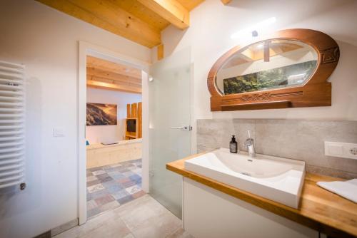 a bathroom with a sink and a mirror at Wohnplatz 52 in Inzigkofen