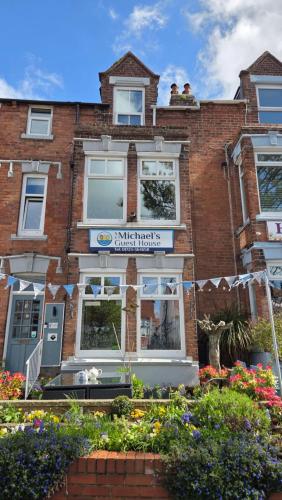 a brick building with a sign that reads pink threads at St Michael's Boutique Guest House, North Bay, Scarborough with free parking and fast wi-fi in Scarborough