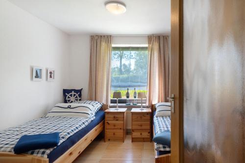 a bedroom with two beds and a window at An der Silberfuchsbörse in Wurster Nordseeküste