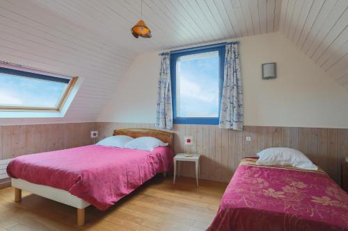 a bedroom with two beds and a window at Bellevue rue de la petite corniche in Perros-Guirec