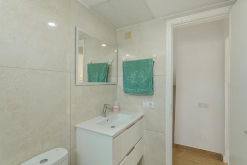 a bathroom with a sink and a toilet and a mirror at Villa Maria Maspalomas Gran Canaria in Maspalomas