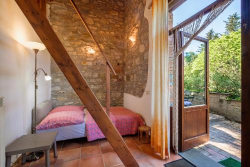 a bedroom with a bed in a room with a window at Stella Nord Podere Carbone in Grosseto