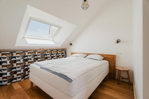 a bedroom with a bed and a window at Logement calme proche centre ville in Rennes