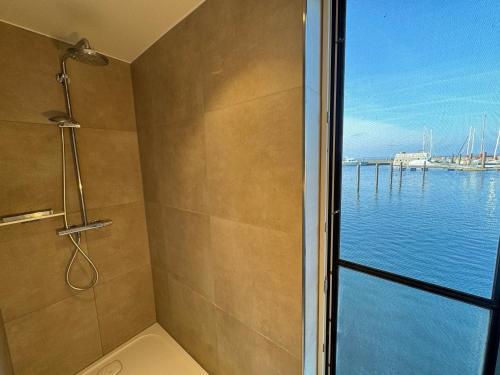 a bathroom with a shower with a view of the water at Floating Home Nr 1 in Laboe