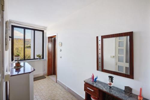 a bathroom with a counter and a mirror on the wall at Casa Isabea in Pozzuoli